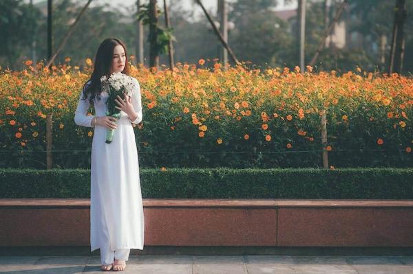 Person posing with a bouquet of Gardenias