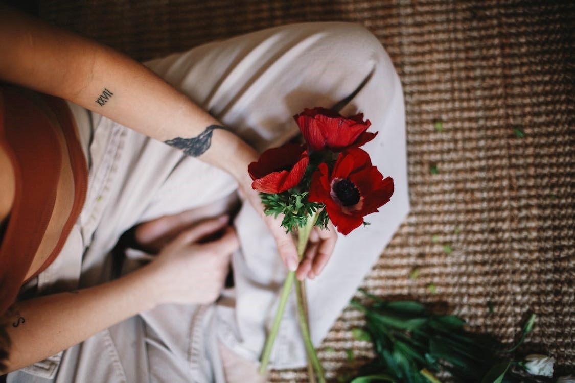 Person with poppies in hand